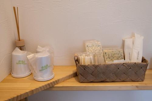 a wooden shelf with a basket of items on it at HOTEL BOTH in Shari