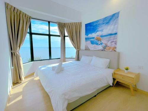 a bedroom with a large bed and a large window at Mutiara Melaka Beach Resort by Minso in Tangga Batu