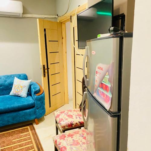 een woonkamer met een koelkast en een bank bij 6 اكتوبر مدينه الشيخ زايد in Sheikh Zayed