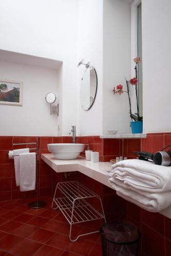a bathroom with a white sink and a mirror at Affittacamere Capri Dolce Vita in Capri