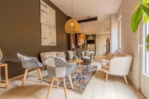 a living room with chairs and a table at Pleasant and bright chartreuse with terrace in Toulouse
