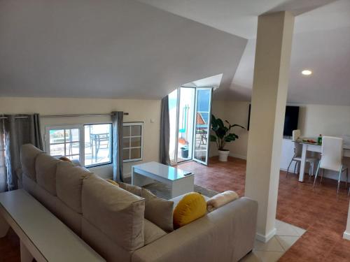 a living room with a couch and a table at Casa Dos Ramos in Arco da Calheta