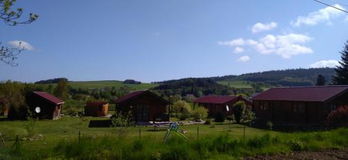 a group of barns in a field with trees at chalets les 5 loups in Gerbépal