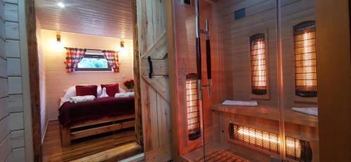 a small room with a bed and a window at Sielanówek - Orzechowa Chatka z sauną wanną termalną jacuzzi in Żywiec