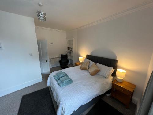 a bedroom with a bed with two pillows on it at Stylish 2nd Floor Georgian 1 Bedroom Apartment in Dumfries