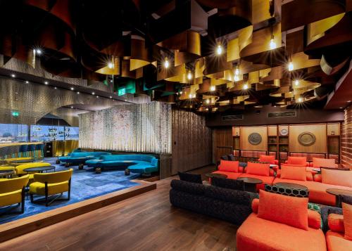 a lobby with orange and blue chairs and tables at The President in Prague