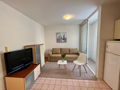 a living room with a couch and a tv at City Place in Split