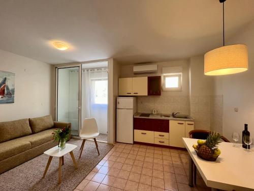 a kitchen and living room with a couch and a table at City Place in Split