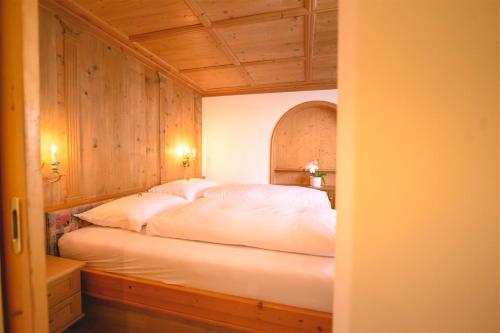 a bedroom with a bed with white sheets and pillows at Haus Barbarahof in Altenmarkt im Pongau