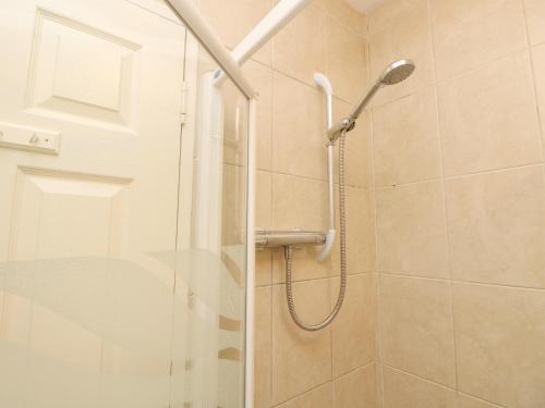 a shower with a glass door in a bathroom at Byewater in Ryde