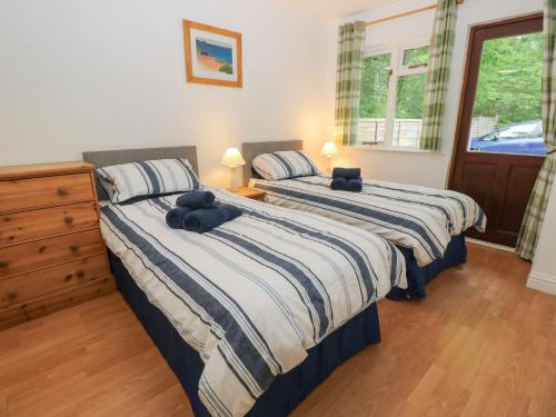 a bedroom with two beds with towels on them at Byewater in Ryde