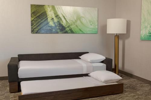 two beds in a room with a lamp at SpringHill Suites by Marriott West Sacramento in West Sacramento