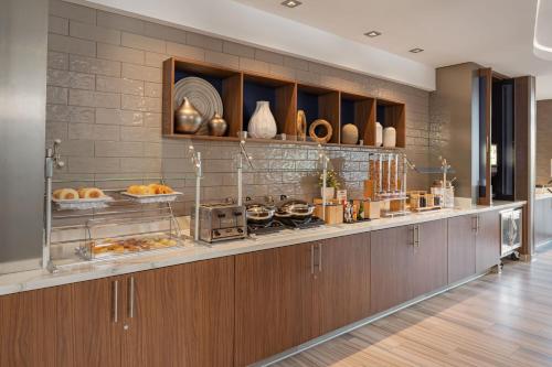 a kitchen with a counter with food on it at SpringHill Suites by Marriott West Sacramento in West Sacramento