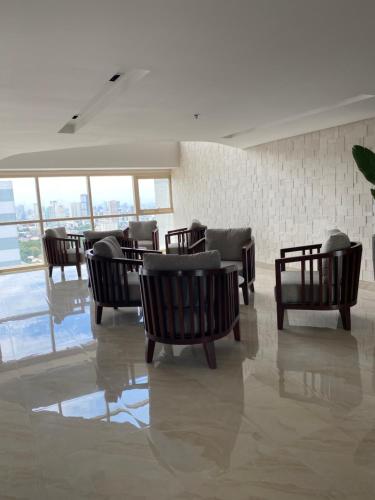 a room with chairs and tables in a building at Coast Residence Pasay in Manila