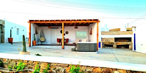 a house with a patio with a fireplace at Blue Serenity Villa in Fanari