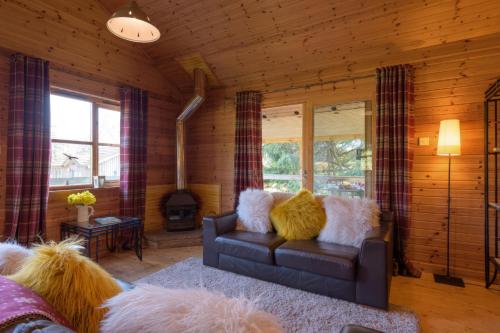 a living room with a couch with furry pillows at Ben Macdui in Banchory