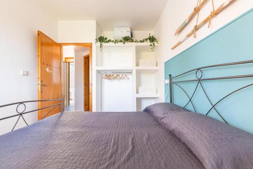 a bedroom with a bed with a purple bedspread at Casa di Gino` by BarbarHouse in San Foca
