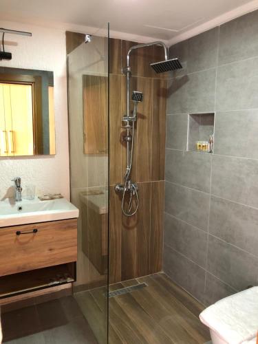 a bathroom with a shower and a sink at Tangiers Hotel Ex Marina Bay in Bodrum City