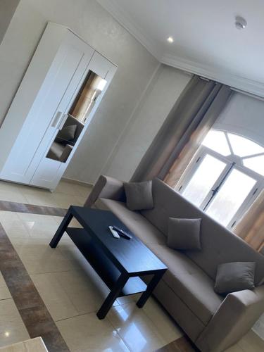 a living room with a couch and a table at AMWAJ HOTEL in El Jadida