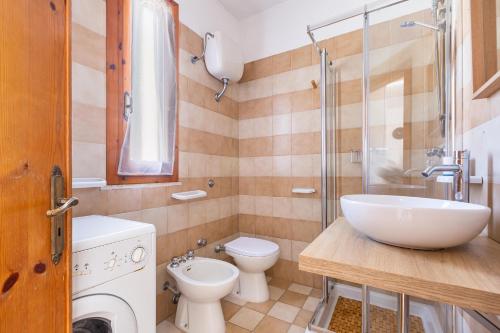 a bathroom with a sink and a toilet and a shower at Casa di Gino` by BarbarHouse in San Foca