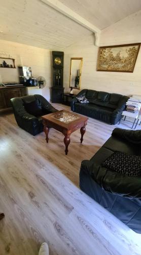 a living room with couches and a coffee table at Rasos kiemelis in Palanga