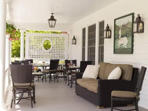 a patio with a couch and tables and chairs at The White Hart in Salisbury