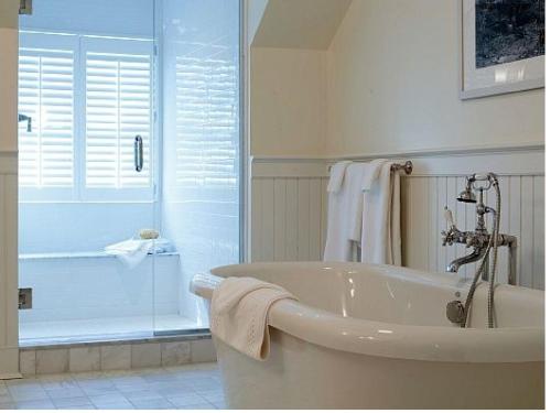 a white bathroom with a tub and a shower at The White Hart in Salisbury