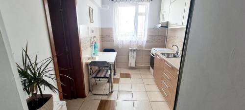 a small kitchen with a sink and a table at Perfect View Apartament in Bucharest