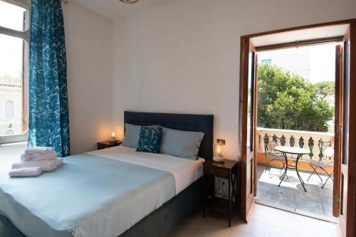 a bedroom with two beds and a large window at Palazzo Moresco in Santa Marinella