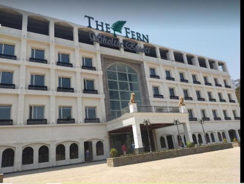 a large white building with a sign on it at The Fern Shelter Resort Palghar in Manor
