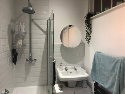 a white bathroom with a sink and a mirror at Victorian Town House in Dover in Dover