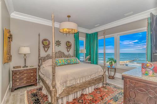a bedroom with a bed with a view of the ocean at Sea Something Beautiful in Myrtle Beach