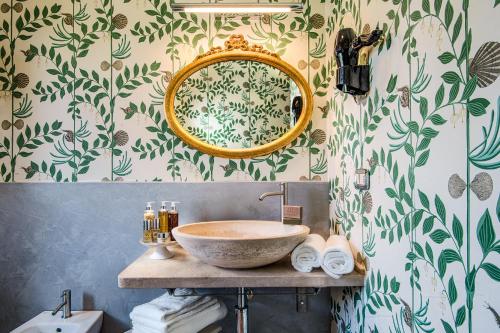 a bathroom with a sink and a mirror at San Giovanni Terme Rapolano in Rapolano Terme