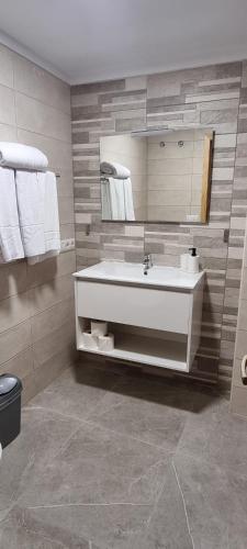 a bathroom with a white sink and a mirror at ESTUDIO LA ESTRELLA in Candelaria