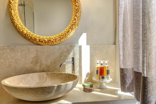 a bathroom with a large bowl sink and a mirror at San Giovanni Terme Rapolano in Rapolano Terme