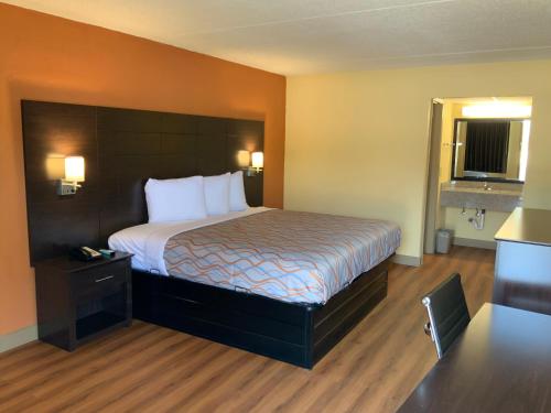 a hotel room with a bed in a room at Days Inn by Wyndham Troy IL in Troy