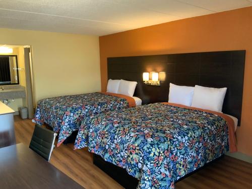 a hotel room with two beds in a room at Days Inn by Wyndham Troy IL in Troy