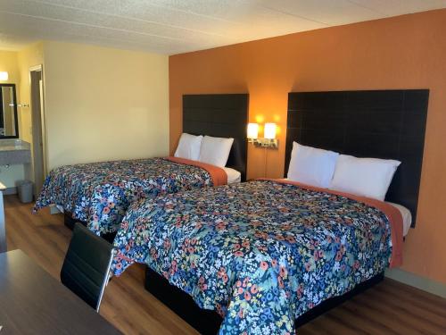 a hotel room with two beds in a room at Days Inn by Wyndham Troy IL in Troy