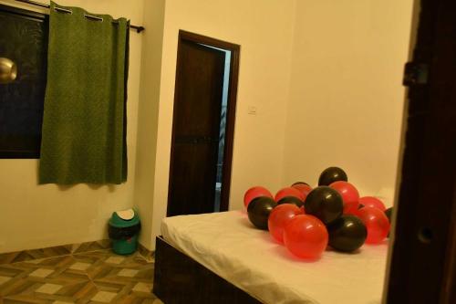 a bunch of balloons on a bed in a room at OYO Hotel Elite in Chandrapur