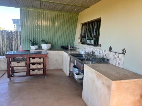 a kitchen with a counter and a sink and a table at Rockey Mountain Tower in Bela-Bela