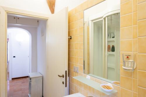 a bathroom with a sink and a mirror at Porto Cervo Centro con piscina, Le Terrazze del Porto in Porto Cervo