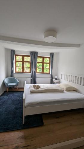 a bedroom with a large bed and a blue rug at LIBORIA III Wohnen im Denkmal Augsburgs in Augsburg