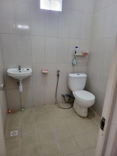 a bathroom with a toilet and a sink at SAMARA VILLA in Batu