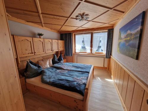 a bedroom with a bed with a wooden ceiling at Ferienwohnung Bergglück in Mayrhofen