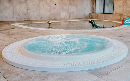 a large pool of water in a bath tub at Blue Baltic & SPA in Dziwnów