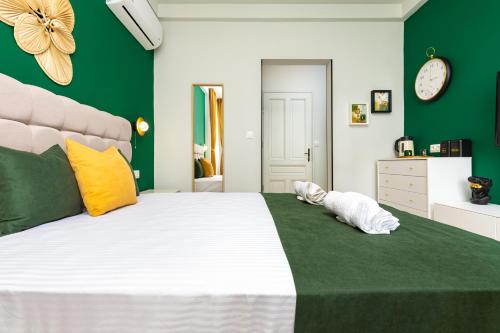 a bedroom with a large bed with green walls at Kapana Guest House on Central Pedestrian street with Parking included in Plovdiv