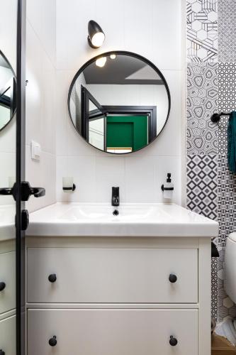 a bathroom with a white sink and a mirror at Kapana Guest House on Central Pedestrian street with Parking included in Plovdiv