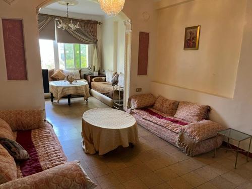 a living room with couches and a table at إقامة 16 ساحة الامم in Tangier