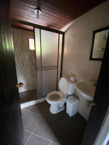 a bathroom with a toilet and a sink at Hacienda Buenos Aires en Iza in Iza