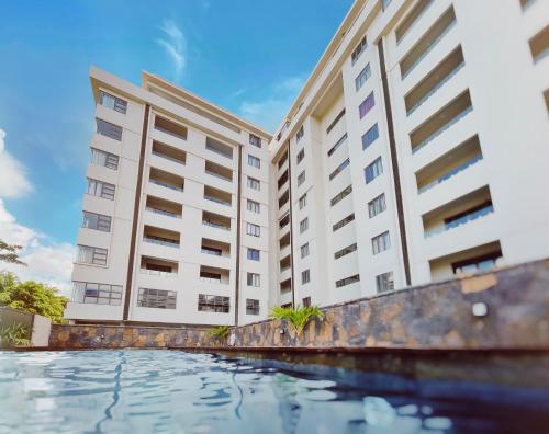 a view of two tall buildings from the pool at Phoenix Valley Suite - Exclusive Apartment + Pool in La Caverne